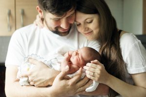 new family holding infant after mom and dad get perinatal counseling in Greenwood, IN for perinatal mood and anxiety disorders at Renewed Hope Counseling 46143