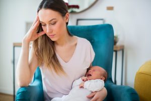 overwhelmed mom suffering from postpartum depression and postpartum anxiety. She gets perinatal counseling in greenwood, in at Renewed Hope Counseling Services 46143